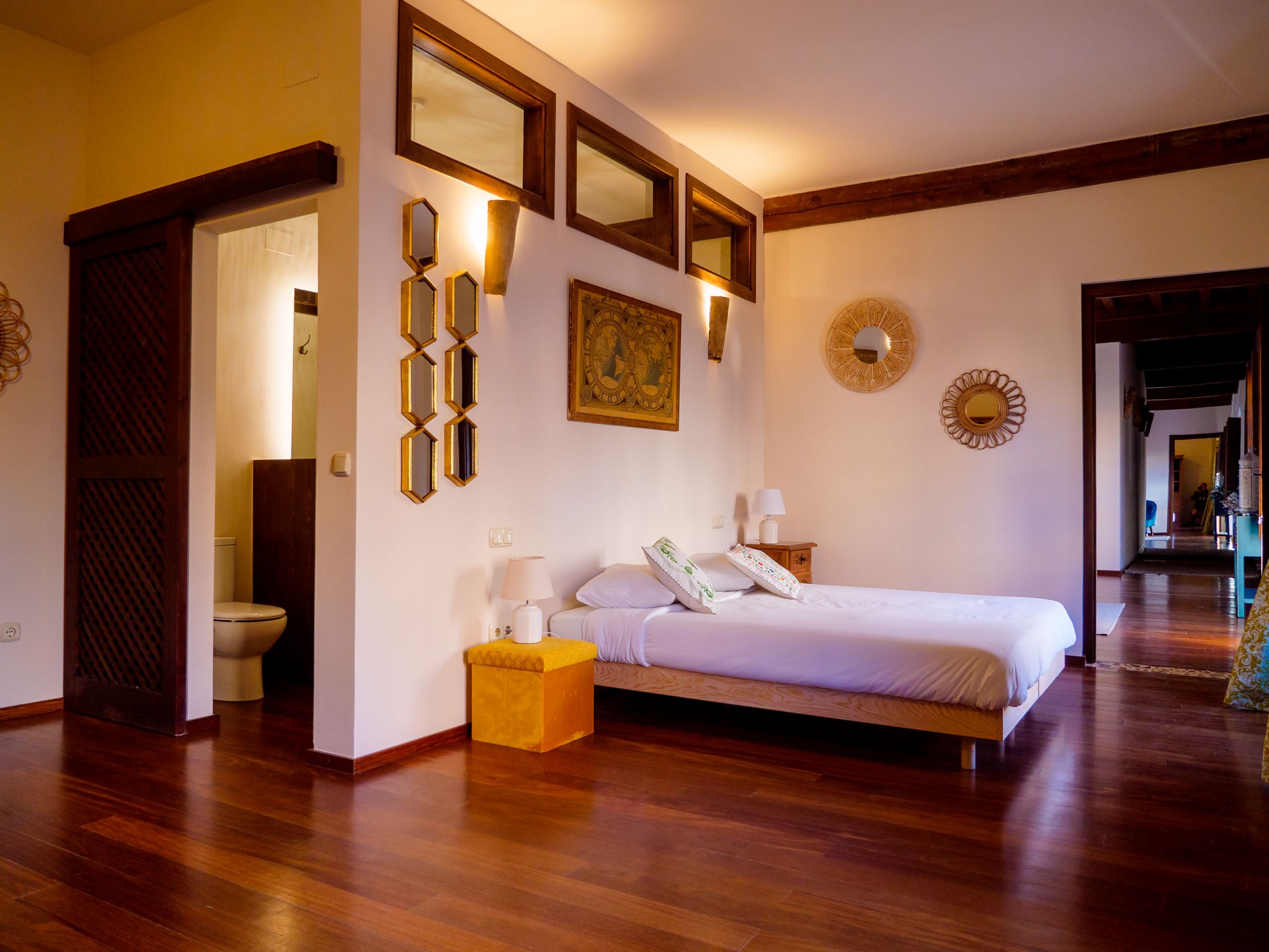 Dormitorio de Casa del Armiño en Toledo con vigas y suelo de madera.
